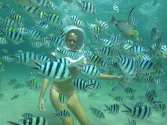 woman underwater on seawalker activity in bali