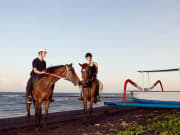 couple on horseback ride in saba beach indonesia