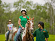 woman with a huge smile while on a horseback ride