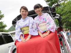 Kimono wearing Japanese women on a rickshaw