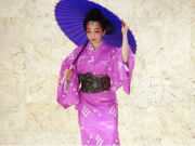 A kimono wearing Okinawan dancer performs