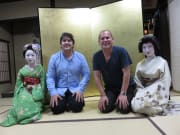 Tourists taking a picture with maiko in kyoto