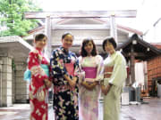 Group posing in yukata, in front of a torii gate