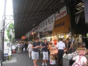 Visitors stopping at a Tsukiji fruit stall