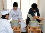 Grinding soba into flour in a classic mortar