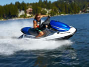 Blasting over the water on a jet ski