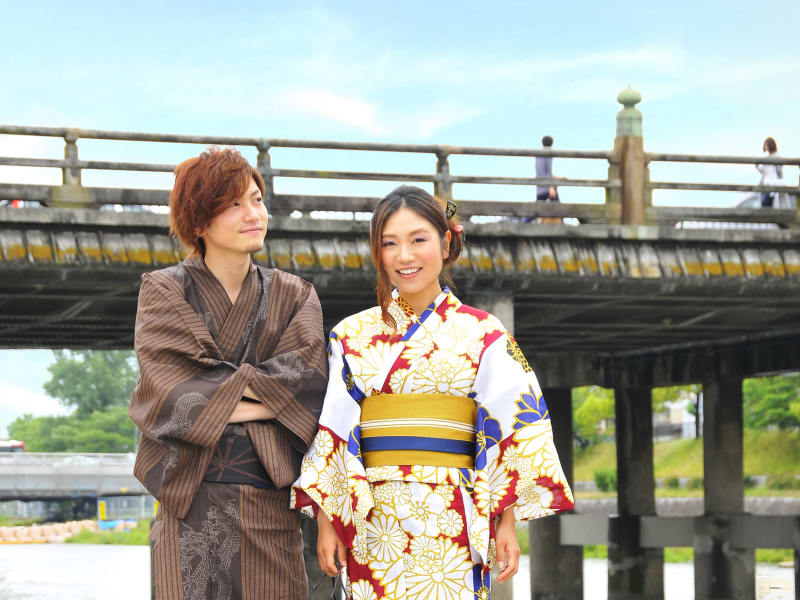 A cute Japanese couple in kimono, walking Kyoto