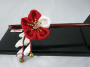 A red and white flower hair stick