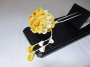 A bright yellow flower styled kanzashi hair piece