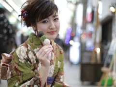 Japanese girl in kimono posing with dango