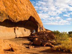 tourists resting at Kitchen Cave in Uluru Ayers