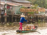 Mekong delta woman selling bread aboard a boat