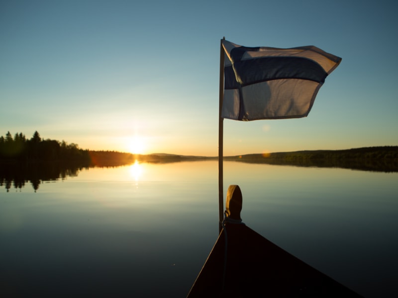 Riverboat cruise under the midnight sun in Lapland