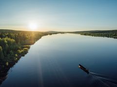 Riverboat cruise under the midnight sun in Lapland