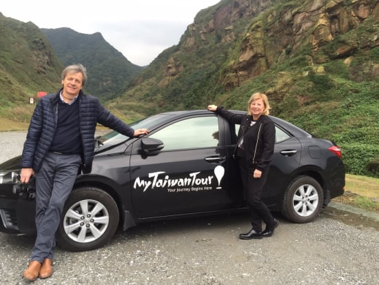 tourists posing outside private car in taiwan tour