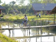 4.Museflower_Retreat&Spa_cycling_over_lake_bridge_grounds