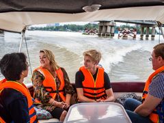 mother and son aboard speedboat across saigon