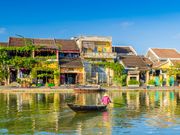 local paddling a boat in Thu Bon River Hoi An