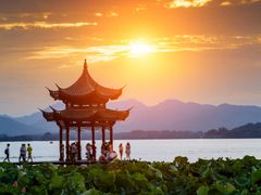 visitors at hangzhou west lake during sunset