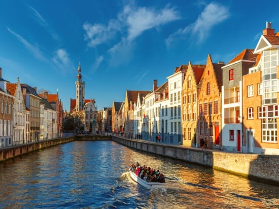 Belgium_Bruges_canal_Spiegelrei_and_Jan_Van_Eyck_Square_Morning_Boat_shutterstock_384744043