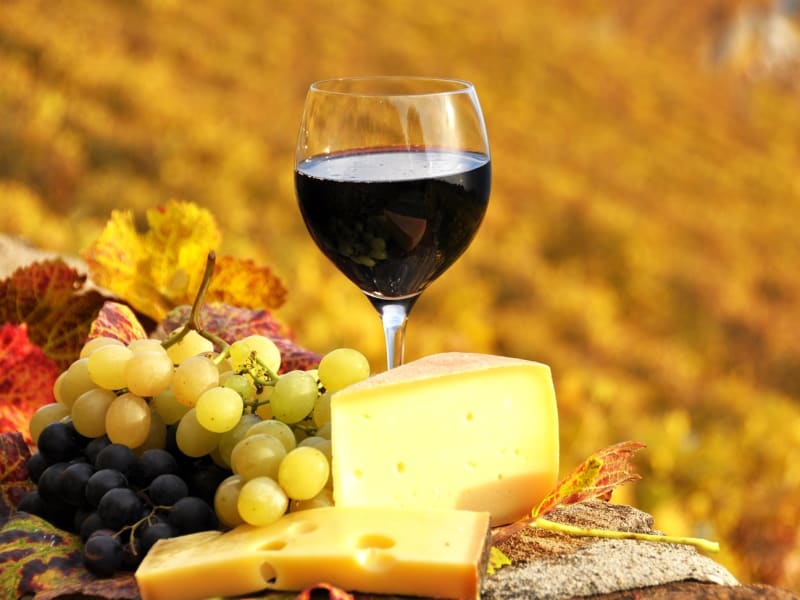 Glass of wine, grapes, and cheese