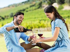 Couple pouring a glass of wine