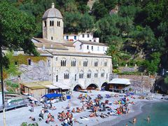 Tourist sunbathing outside San Fruttuoso Abbey