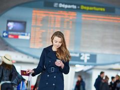airport woman browsing phone while waiting