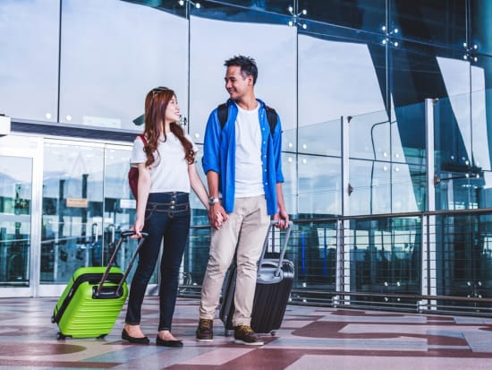 Generic_Airport_Asian-Couple-with-Luggage_shutterstock_722079019