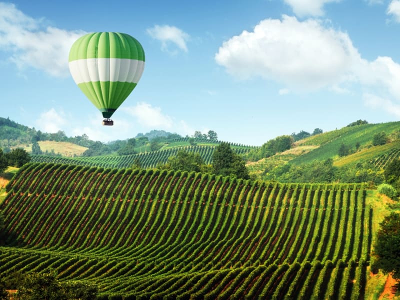 hot air balloon, rolling hills, tuscany