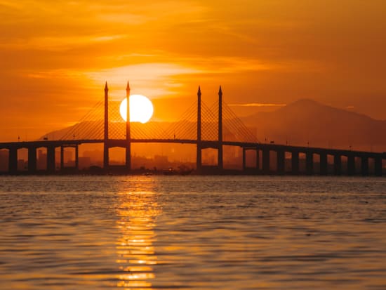 Malaysia_Penang_George Town_Bridge with sunset_shutterstock_1786968143