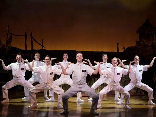 Stephen Ashfield, center, as Elder McKinley, and company in The Book of Mormon 406