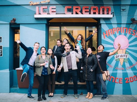 Brooke Porter. Mission District Food Tour. Guests jumping silly infront of Bi Rite Creamery