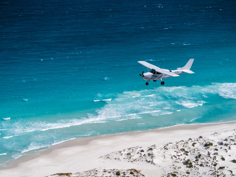 Cessna 206 over beach