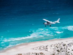 Cessna 206 over beach