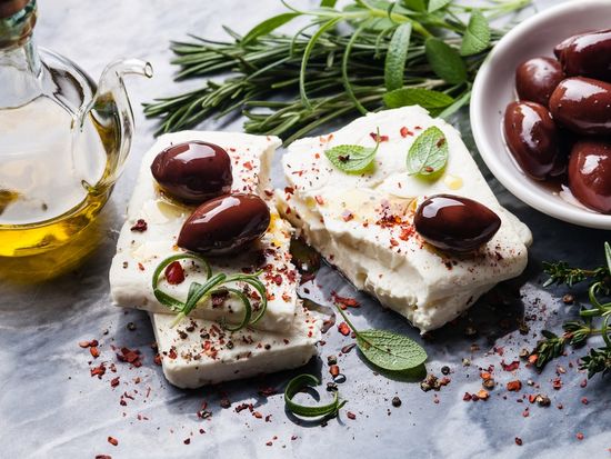 Greece_Feta_cheese_with_olives_and_green_herbs_shutterstock_255256354