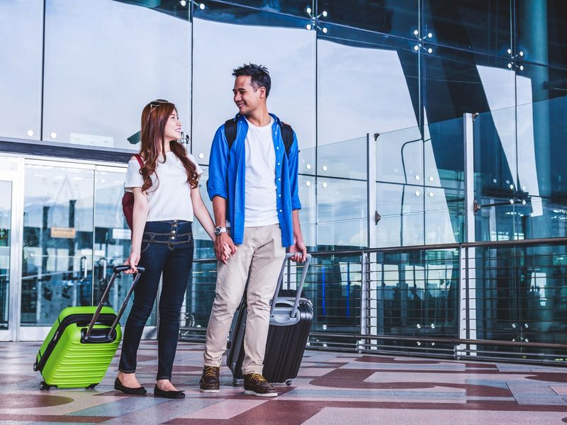 Generic_Airport_Asian-Couple-with-Luggage_shutterstock_722079019