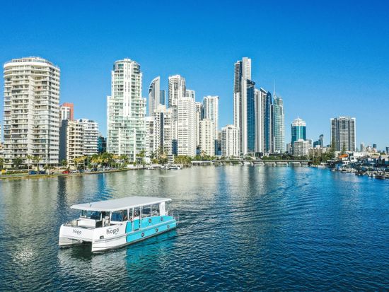 6. TheTourCollective_Hopo_Gold Coast_Hop On Hop Off_hopo with gold coast buildings_TTC08493