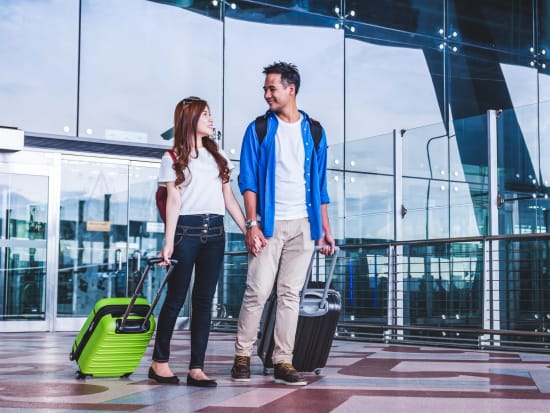 Generic_Airport_Asian-Couple-with-Luggage_shutterstock_722079019