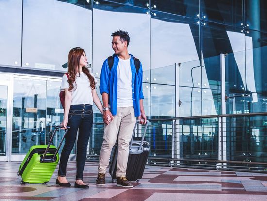 Generic_Airport_Asian-Couple-with-Luggage_shutterstock_722079019