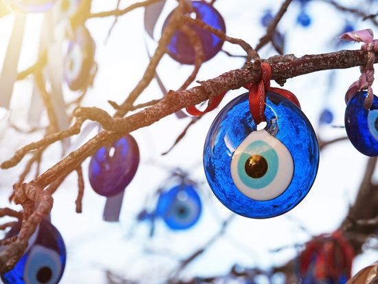 evil-eyes-turkish-famous-amulet-decorations-hanging-branches-with-sunlight