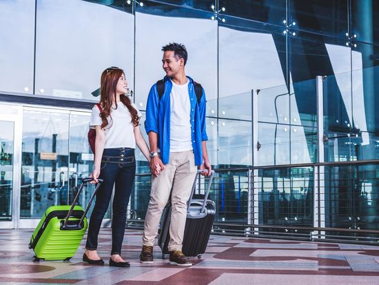 Generic_Airport_Asian-Couple-with-Luggage_shutterstock_722079019