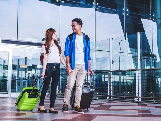 Generic_Airport_Asian-Couple-with-Luggage_shutterstock_722079019