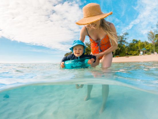 Infant swimming in waters at Green Island 