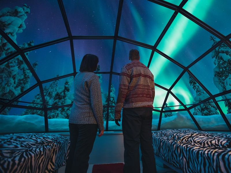 Kakslauttanen glass igloo inside Northern Lights