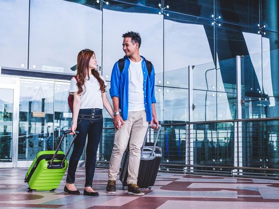 Generic_Airport_Asian-Couple-with-Luggage_shutterstock_722079019